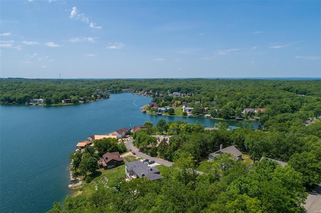bird's eye view featuring a wooded view and a water view