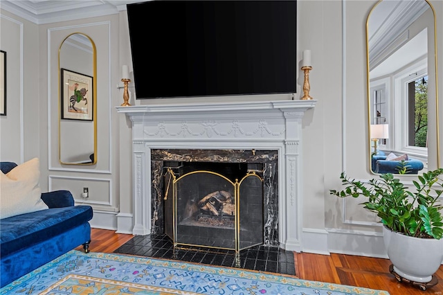 details featuring a high end fireplace, wood finished floors, and ornamental molding