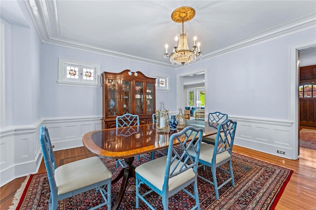 dining room featuring a wealth of natural light, wood finished floors, and a chandelier