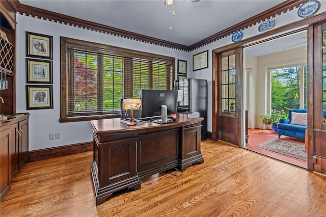 office featuring light wood-style floors, baseboards, ceiling fan, and visible vents