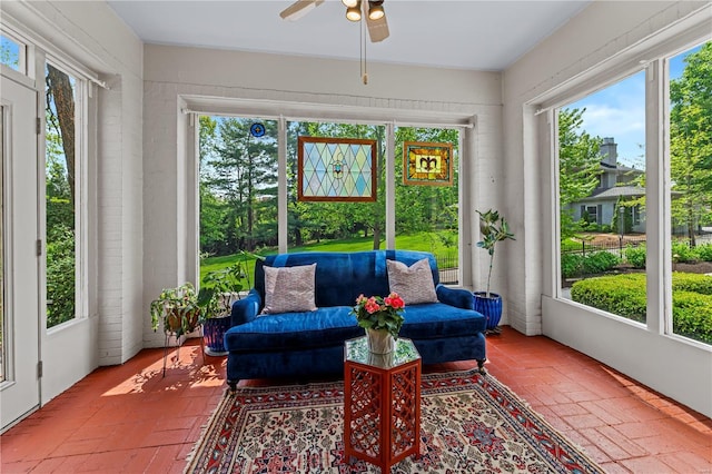 sunroom / solarium featuring ceiling fan and a wealth of natural light