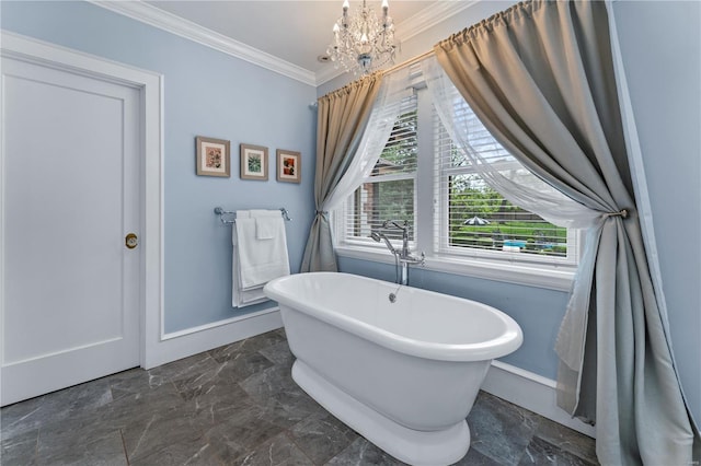 full bathroom with baseboards, a notable chandelier, ornamental molding, and a freestanding bath