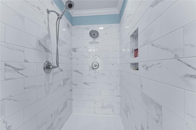 bathroom with crown molding and tiled shower