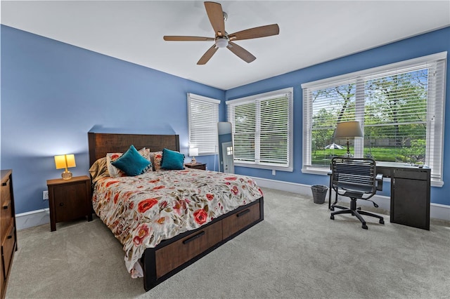 carpeted bedroom with baseboards and ceiling fan