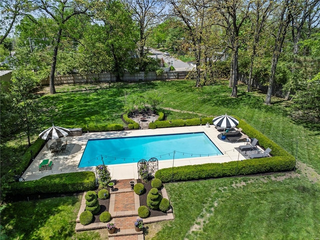 view of swimming pool featuring a yard, a fenced in pool, a fenced backyard, and a patio area