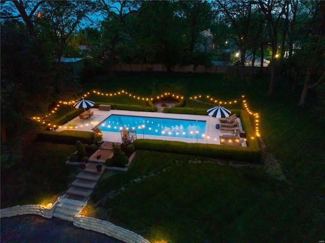 pool featuring a yard, a fenced backyard, a patio area, and an outdoor fire pit
