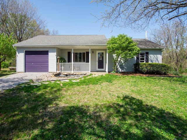 ranch-style house featuring an attached garage, driveway, a front yard, and covered porch