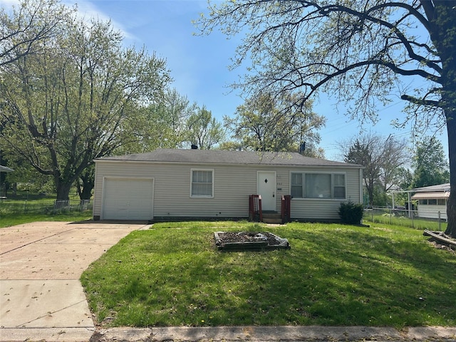 view of front of property with concrete driveway, fence, a front yard, and a garage