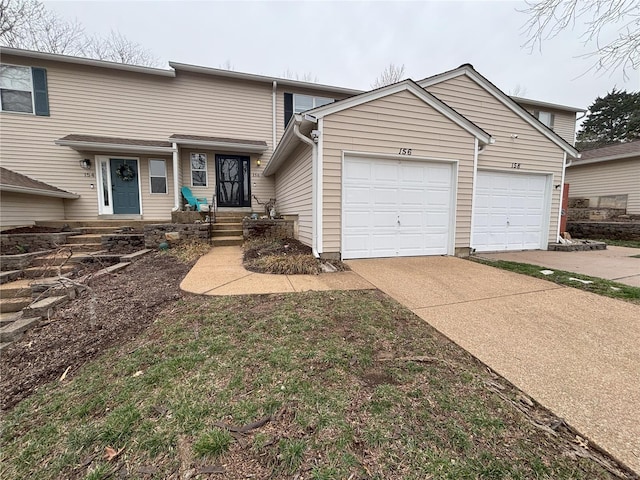 view of front of home with concrete driveway and a garage