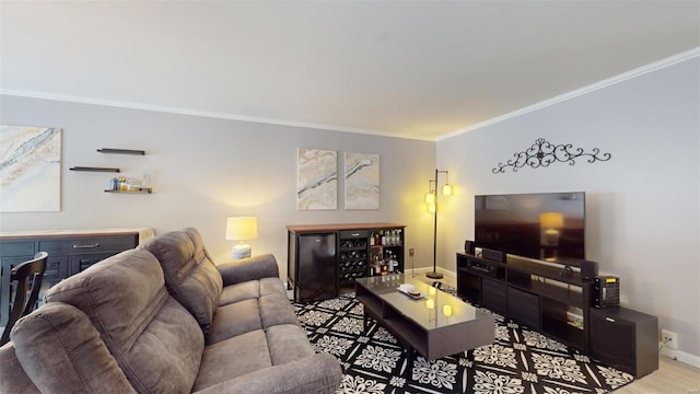 living room with baseboards, crown molding, and wood finished floors