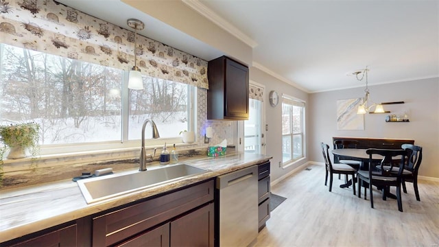 kitchen with light wood finished floors, stainless steel dishwasher, a sink, and ornamental molding