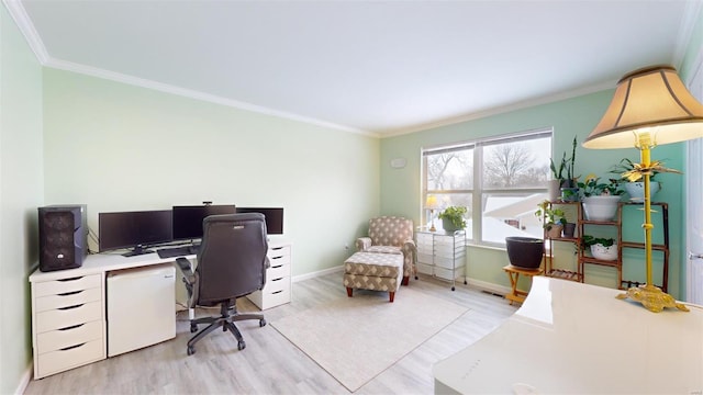 office area with light wood-type flooring, baseboards, visible vents, and crown molding