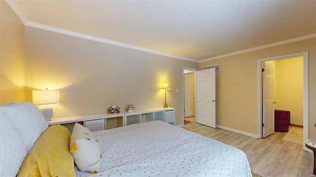 bedroom with baseboards, crown molding, visible vents, and light wood-style flooring