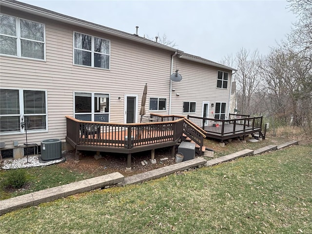 back of house with a wooden deck, a yard, and central air condition unit