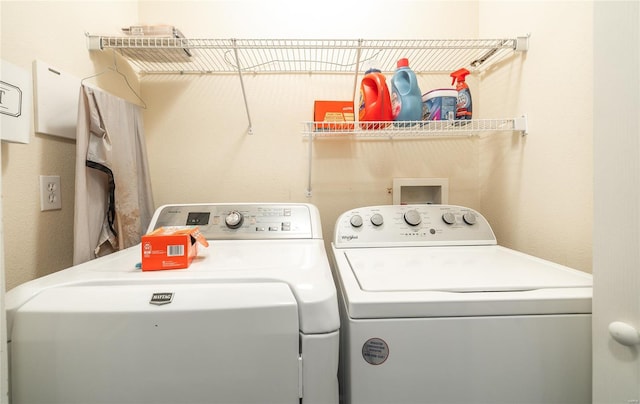 laundry room with separate washer and dryer and laundry area