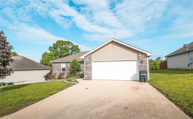 ranch-style home with concrete driveway, an attached garage, a front lawn, and brick siding
