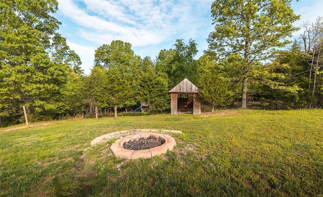 view of yard with a fire pit