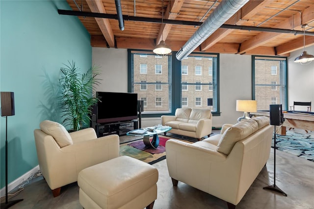 living room with a healthy amount of sunlight, wood ceiling, finished concrete flooring, and beam ceiling
