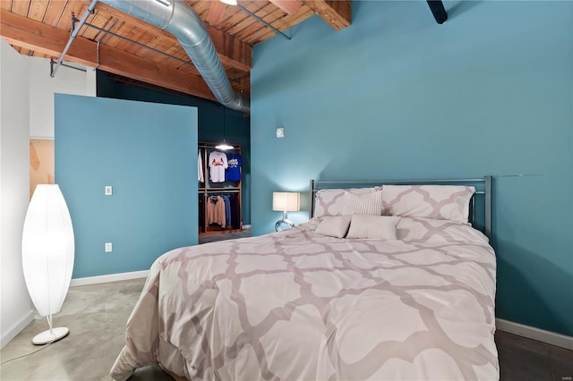 bedroom with baseboards, wood ceiling, a closet, and beamed ceiling