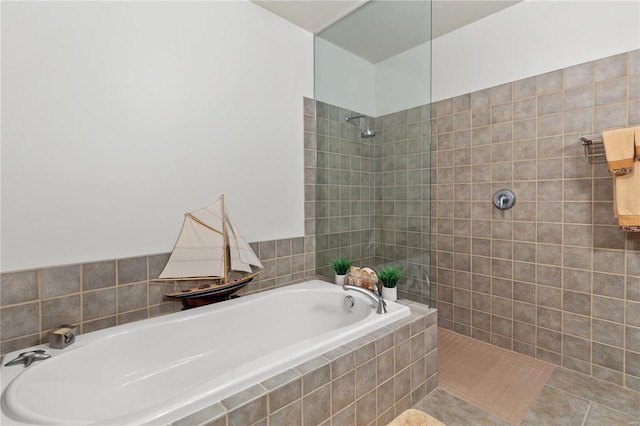 bathroom featuring a walk in shower and a bath