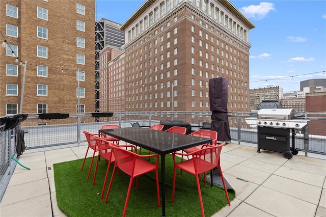 view of patio / terrace with fence, outdoor dining area, and grilling area