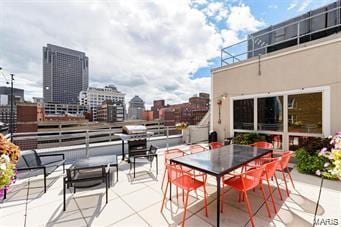 view of patio featuring a view of city and outdoor dining area
