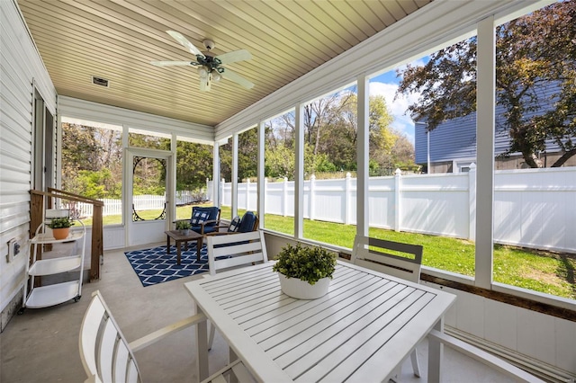 sunroom / solarium featuring ceiling fan, outdoor dining space, and plenty of natural light