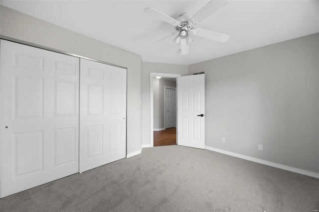 unfurnished bedroom featuring baseboards, carpet, a closet, and ceiling fan