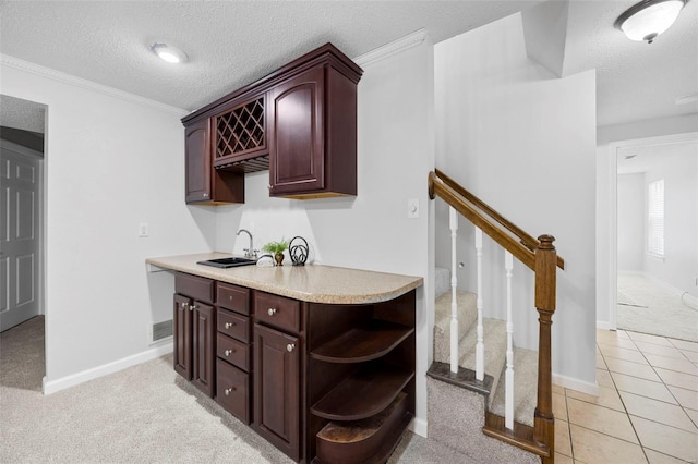 bar featuring stairs, a sink, a textured ceiling, light carpet, and baseboards