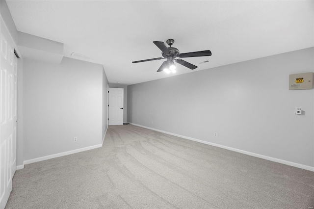 carpeted empty room featuring visible vents, baseboards, and ceiling fan