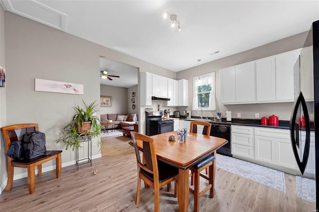 dining space featuring rail lighting, visible vents, ceiling fan, and light wood-style floors