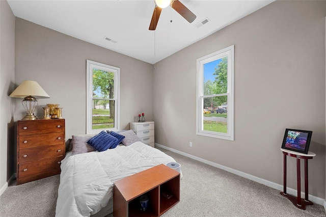 bedroom featuring baseboards, ceiling fan, carpet floors, and visible vents