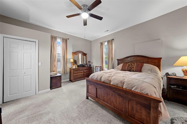 bedroom with baseboards, visible vents, multiple windows, and light colored carpet