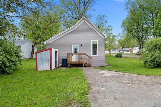 rear view of property with a yard