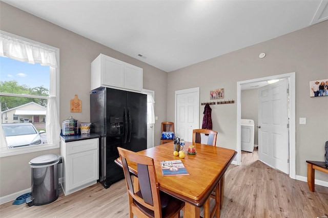 dining space with washer / dryer, baseboards, and light wood-style floors