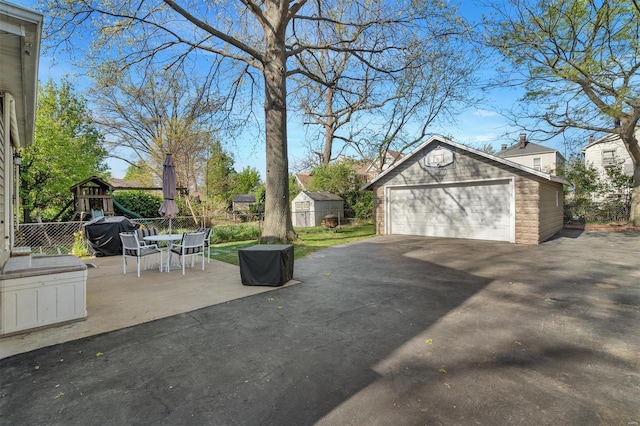 detached garage featuring fence