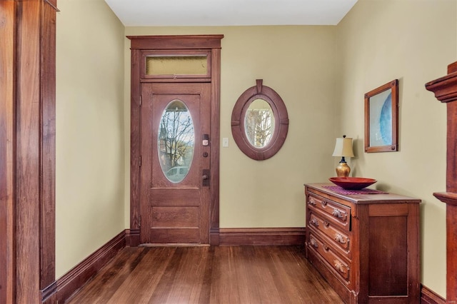 entryway with dark wood finished floors and baseboards