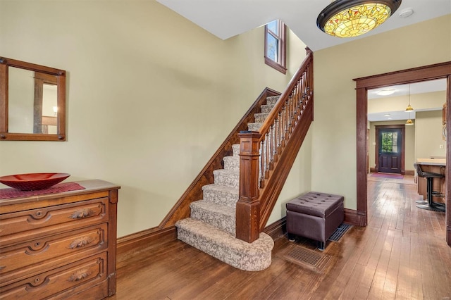 stairs with baseboards and wood-type flooring