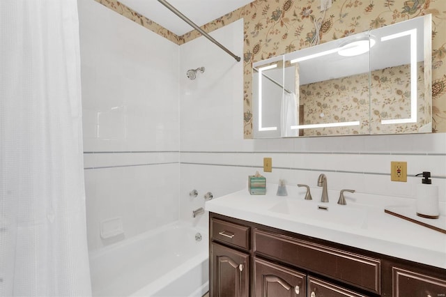 full bathroom with shower / bath combo, vanity, and wallpapered walls