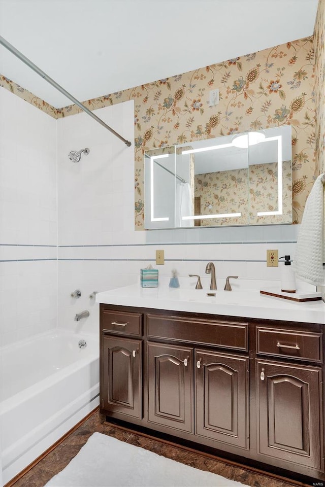 bathroom featuring vanity, shower / washtub combination, and wallpapered walls