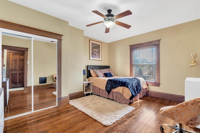 bedroom with visible vents, baseboards, wood finished floors, and ceiling fan
