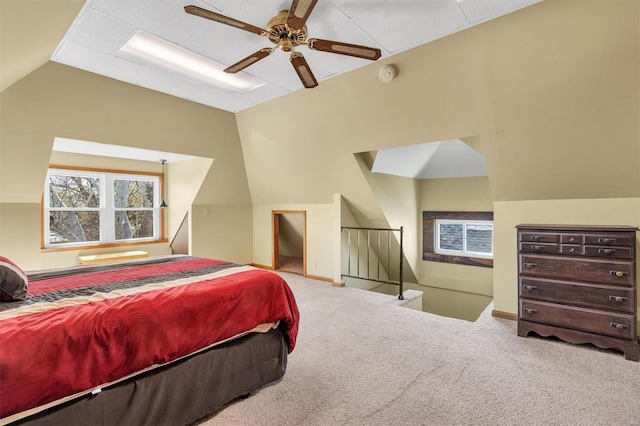 bedroom with lofted ceiling, a ceiling fan, and carpet flooring