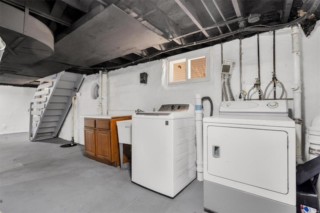 laundry room with washing machine and dryer and cabinet space