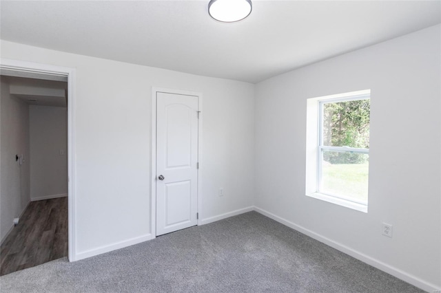 unfurnished bedroom with carpet floors and baseboards