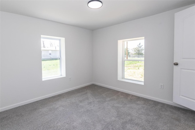 spare room featuring baseboards and carpet