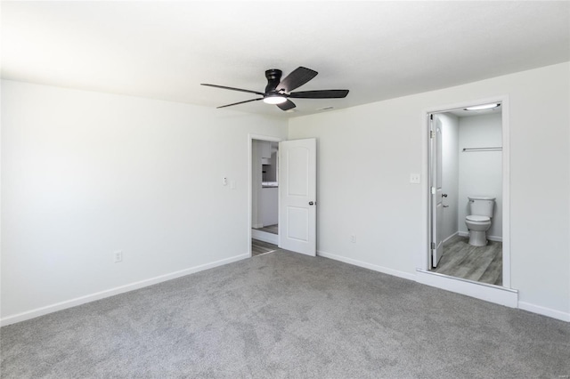 unfurnished bedroom with ensuite bathroom, baseboards, carpet, and a ceiling fan