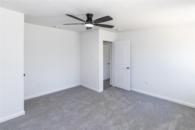 unfurnished bedroom featuring ceiling fan, baseboards, carpet flooring, and visible vents