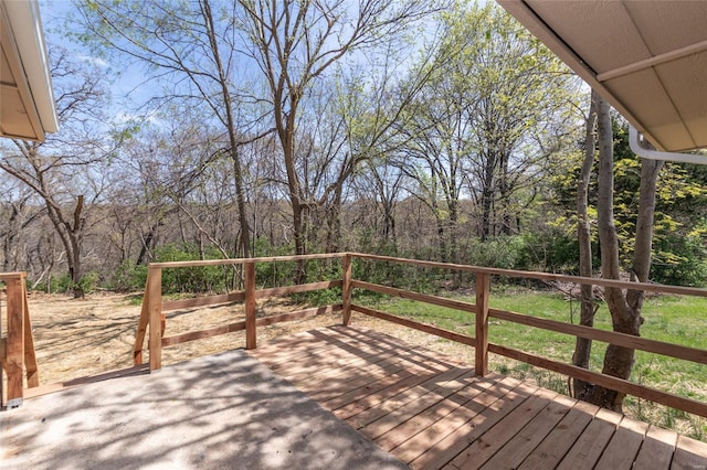 wooden terrace featuring a wooded view
