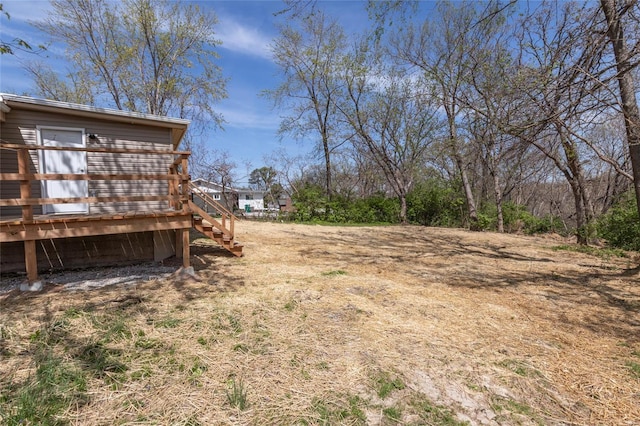 view of yard with a wooden deck and stairway