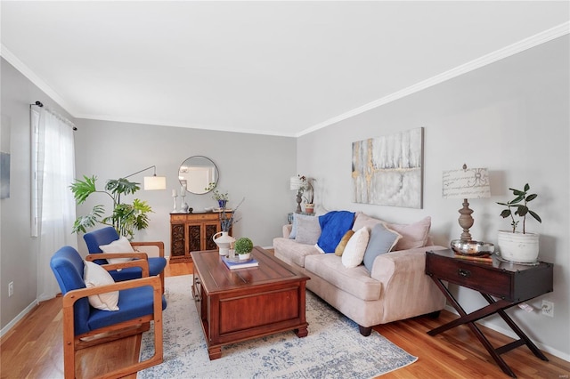 living area with baseboards, ornamental molding, and wood finished floors